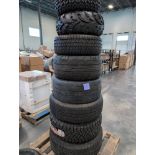 pallet of large tires with rims and wheels
