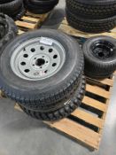 pallet of tires with rims