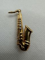 18ct Gold and Diamond Saxophone Shaped Brooch.