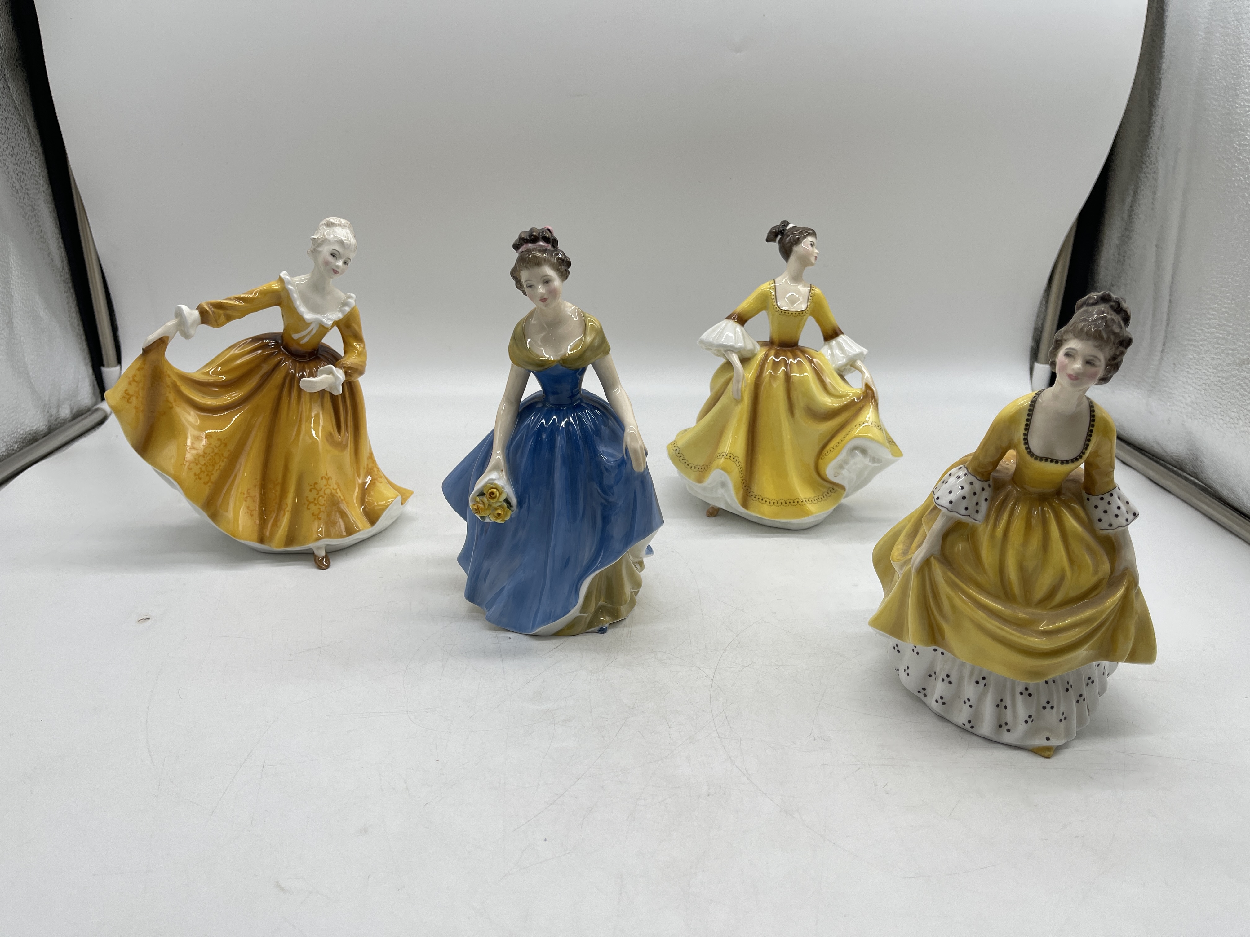 Yellow Royal Doulton ceramic figurines