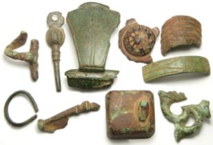 Roman artefact group including a statue base with left foot attached, Aesica brooch, dolphin brooch,