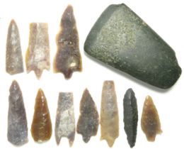 Stone axehead and flint arrowhead group. A varied collection including a polished greenstone axehead