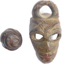 Iron age anthropomorphic vessel mount in the form of a moustachioed human facemask with vacant eye