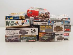 A group of unbuilt plastic military vehicle and figure kits in various scales by ITALERI, TAMIYA and
