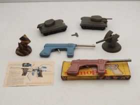 A group of vintage Eastern European tinplate military toys comprising clockwork tanks, pistols,