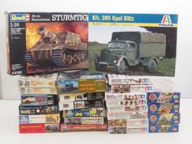 A group of unbuilt plastic military vehicle and figure kits in various scales by AIRFIX, REVELL,