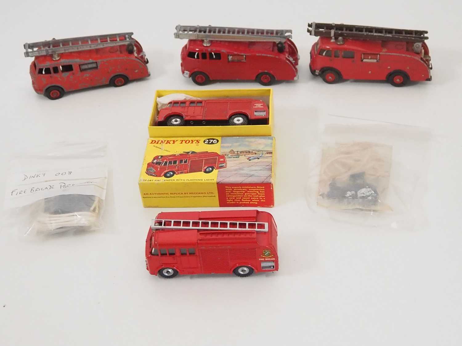 A group of boxed and unboxed DINKY fire engines together with two DINKY 008 fire brigade personnel