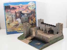 A BRITAINS 'Knights of the Sword' Lion Castle in original box together with a vintage wooden fort by