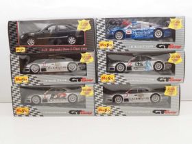 A MAISTO Trade Box containing six 1:18 scale cars, mostly GT racing examples - all as new in box -