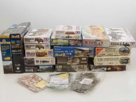 A group of unbuilt plastic military vehicle and figure kits in various scales by AIRFIX, TAMIYA ,