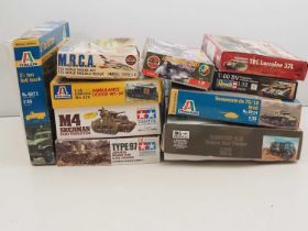 A group of unbuilt plastic military vehicle kits in various scales by IBG, ITALERI, TAMIYA and