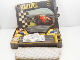 A TRIANG SCALEXTRIC Grand Prix racing set to include an additional box of track - one car