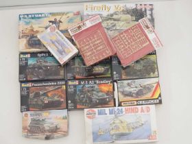 A group of unbuilt plastic military vehicle kits in various scales by DRAGON, AIRFIX, REVELL and