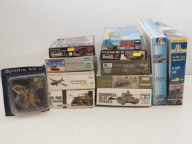 A group of unbuilt plastic military vehicle kits in various scales by HASEGAWA, REVELL, ITALERI