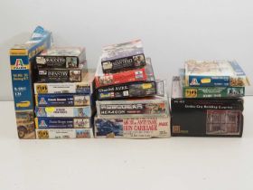 A group of unbuilt plastic military vehicle and figure kits in various scales by ITALERI, REVELL,