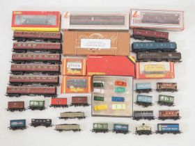 A large quantity of mostly unboxed OO gauge rolling stock by HORNBY, LIMA and others together with a