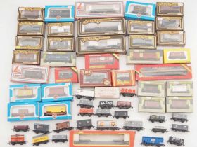 A large quantity of OO gauge boxed and unboxed wagons by MAINLINE, AIRFIX, WRENN and others - G/VG