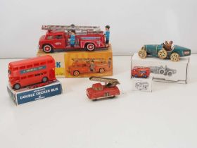 A group of vintage and reproduction clockwork and friction tinplate and plastic toys to include