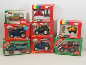 A group of 1:32 scale diecast tractors and agricultural vehicles by BRITAINS and SIKU - G/VG in F/