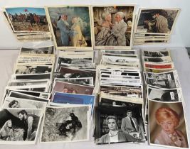 A large quantity of promotional stills from a variety of movies in colour and black and white,