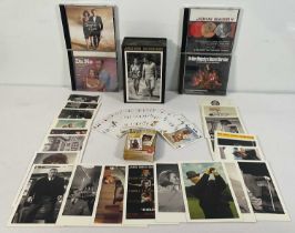 A collection of JAMES BOND memorabilia including a set of 100 50th anniversary postcards, a deck