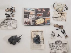 A group of vintage Star Wars small vehicles all unboxed, mostly with instructions, together with a