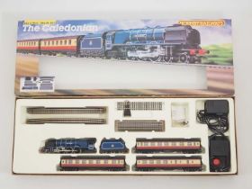 A HORNBY OO gauge 'The Caledonian' passenger train set, appears complete - VG in VG box