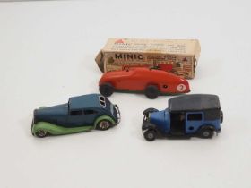 A group of vintage TRIANG MINIC clockwork vehicles comprising a boxed racing car and an unboxed
