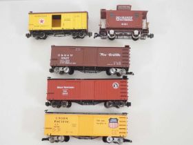 A group of G scale American Outline box cars and a caboose by BACHMANN all with upgraded running