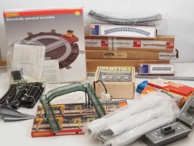 A large box of OO gauge model railway track, accessories and controller including various lengths of