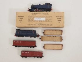 A group of 009 scale rolling stock comprising a 2-8-4 steam tank loco and a Bo-Bo diesel loco both