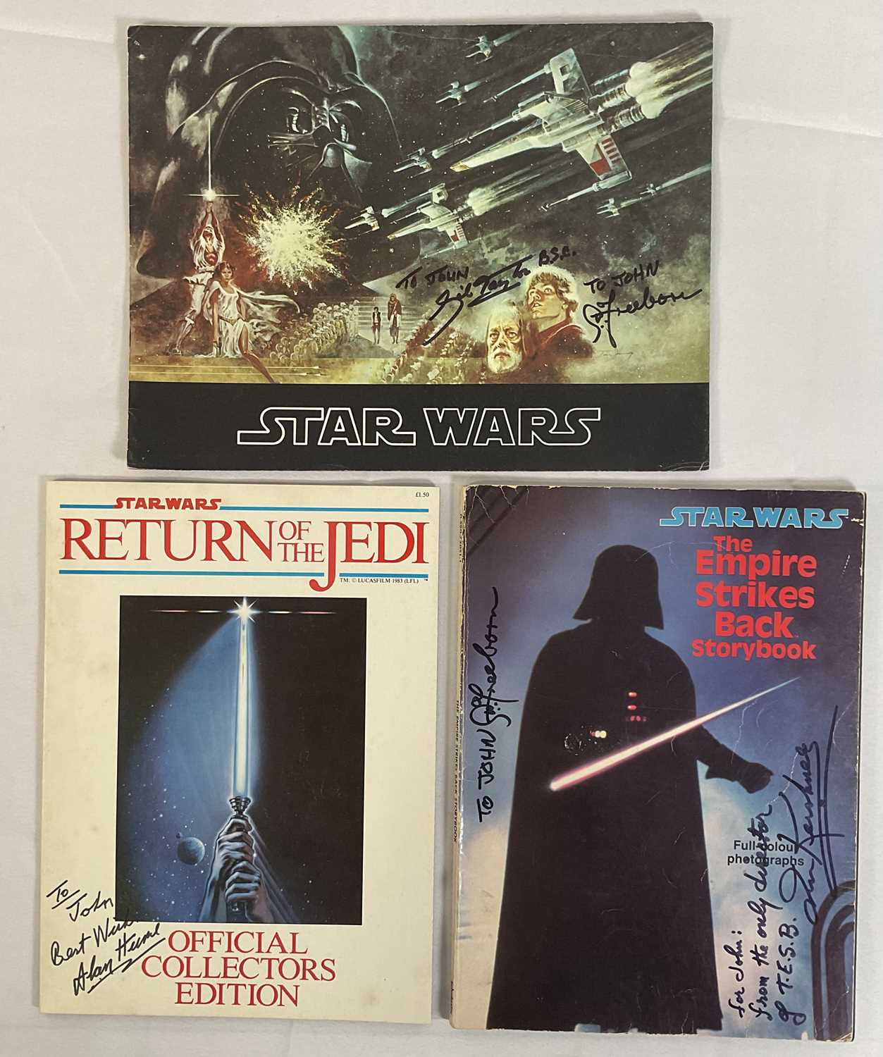 A group of autographed movie souvenir program books to include STAR WARS EPISODE IV: A NEW HOPE (