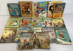 A collection of Rupert the Bear, Disney, and other children's annuals including Mickey Mouse,
