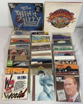 A collection of 7" singles of various titles including THE RAMONES, ELTON JOHN, MADONNA, ADAM AND