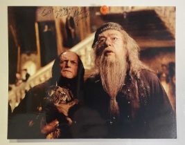 An autographed photographic still from HARRY POTTER signed by MICHAEL GAMBON (Professor Dumbledore),