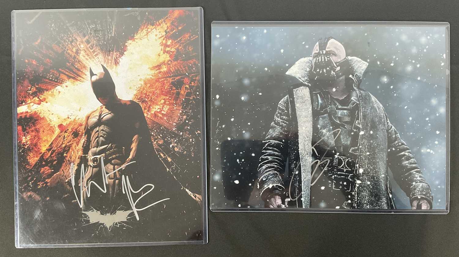 A pair of large format photographic stills from BATMAN THE DARK KNIGHT RISES signed by CHRISTIAN