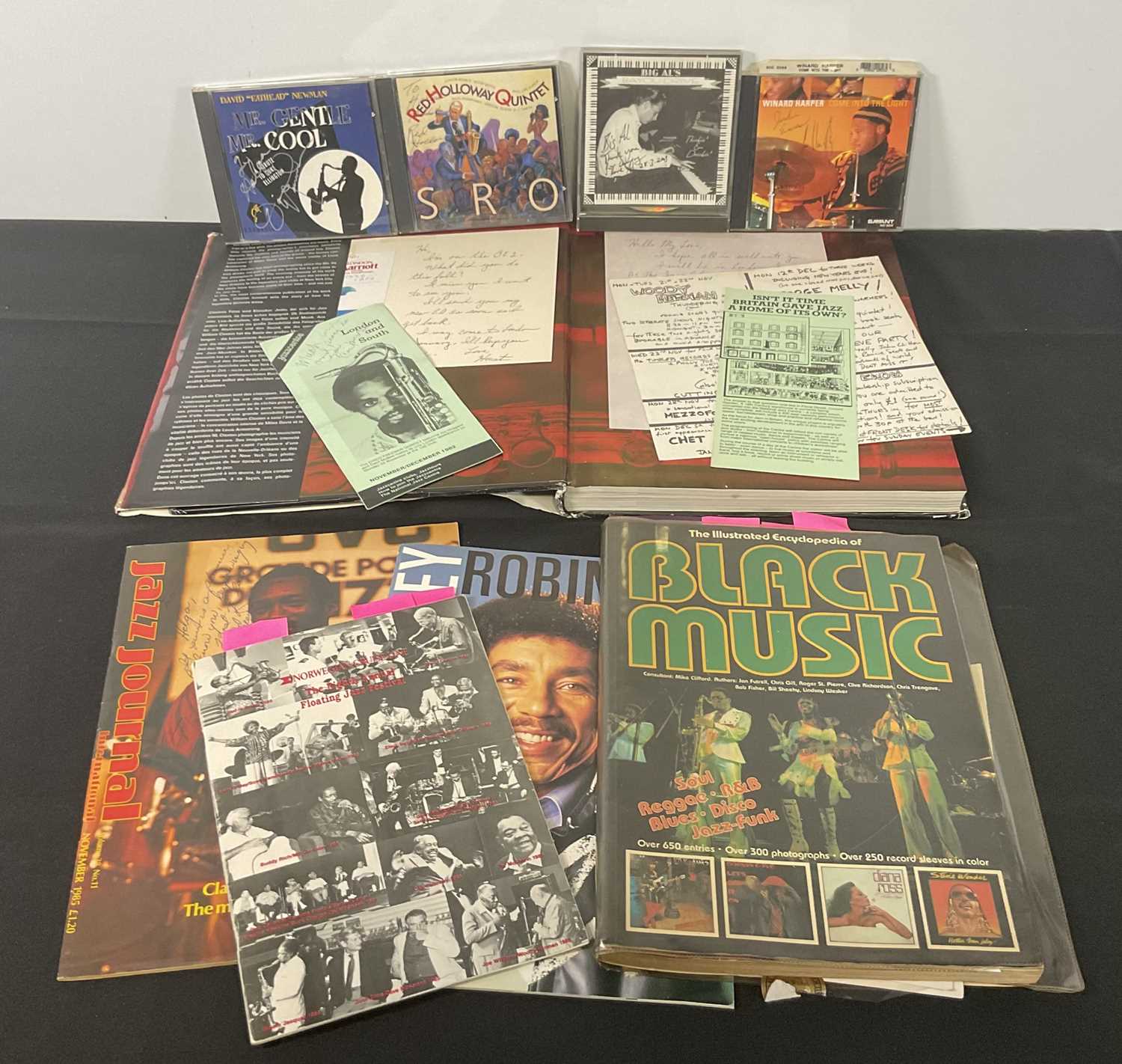 A collection of Jazz musician autographs to include a copy of The Illustrated Encyclopedia of