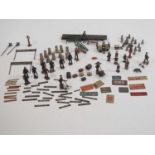 A large group of O gauge lead figures and accessories together with tinplate signs and accessories