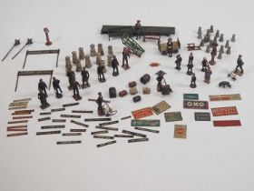 A large group of O gauge lead figures and accessories together with tinplate signs and accessories