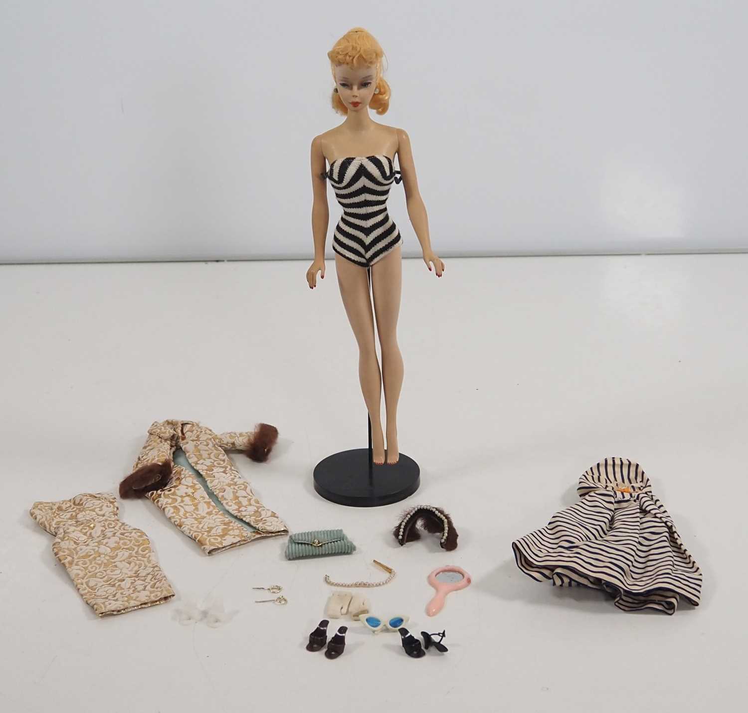 An original vintage MATTEL BARBIE doll, circa 1959/60, complete with swimsuit, mule shoes,