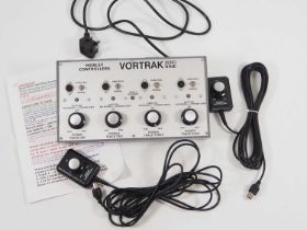 A MORLEY CONTROLLERS OO gauge 4-track Vortrak controller together with two plug in hand controllers,