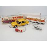 A pair of vintage Eastern European plastic bodied battery operated remote control vehicles