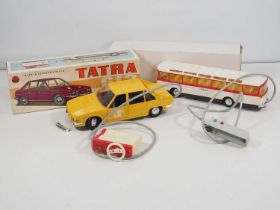A pair of vintage Eastern European plastic bodied battery operated remote control vehicles