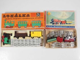 A pair of IGRA Czechoslovakian vintage play train sets comprising 1 x plastic and 1 x tinplate