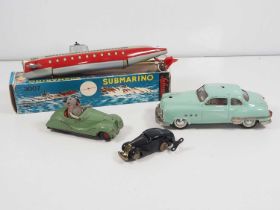 A group of SCHUCO vintage tinplate vehicles comprising a boxed submarine and three cars - F/G in F/G