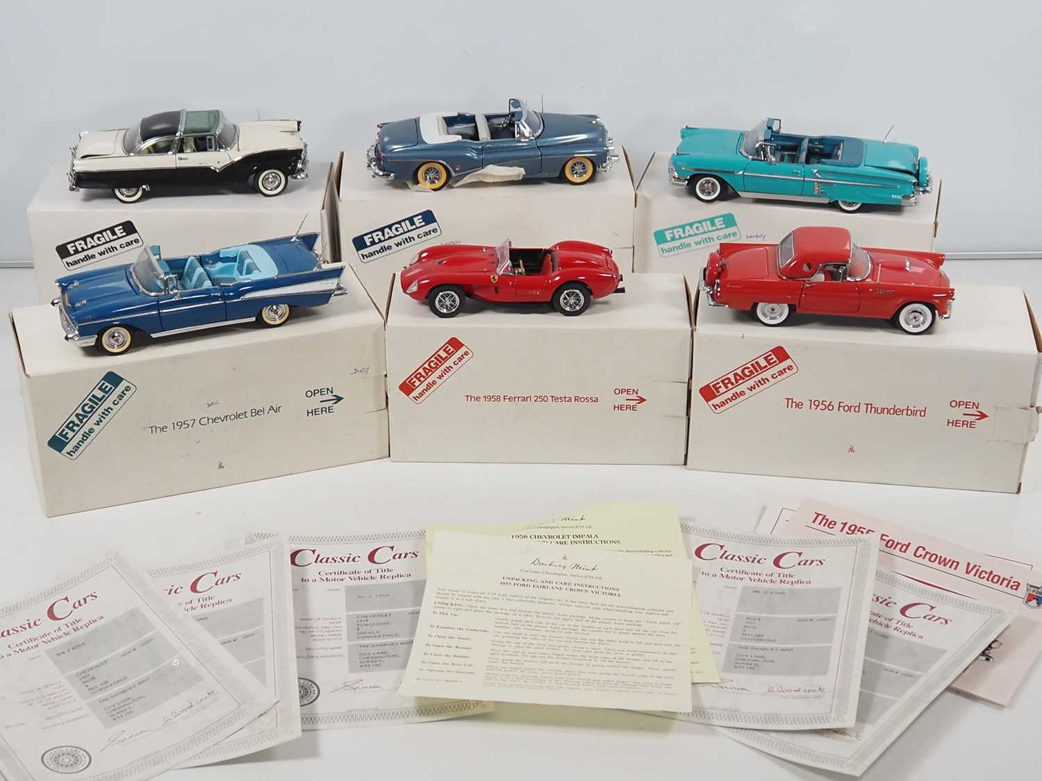 A group of 1:24 scale DANBURY MINT diecast cars to include a 1957 Chevrolet Bel Air and a Ferrari