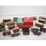 A large group of boxed and unboxed O gauge wagons and coaches by BASSETT-LOWKE, HORNBY and