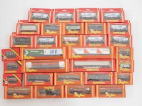 A large group of HORNBY boxed OO gauge wagons of various types including hoppers and Freightliners -