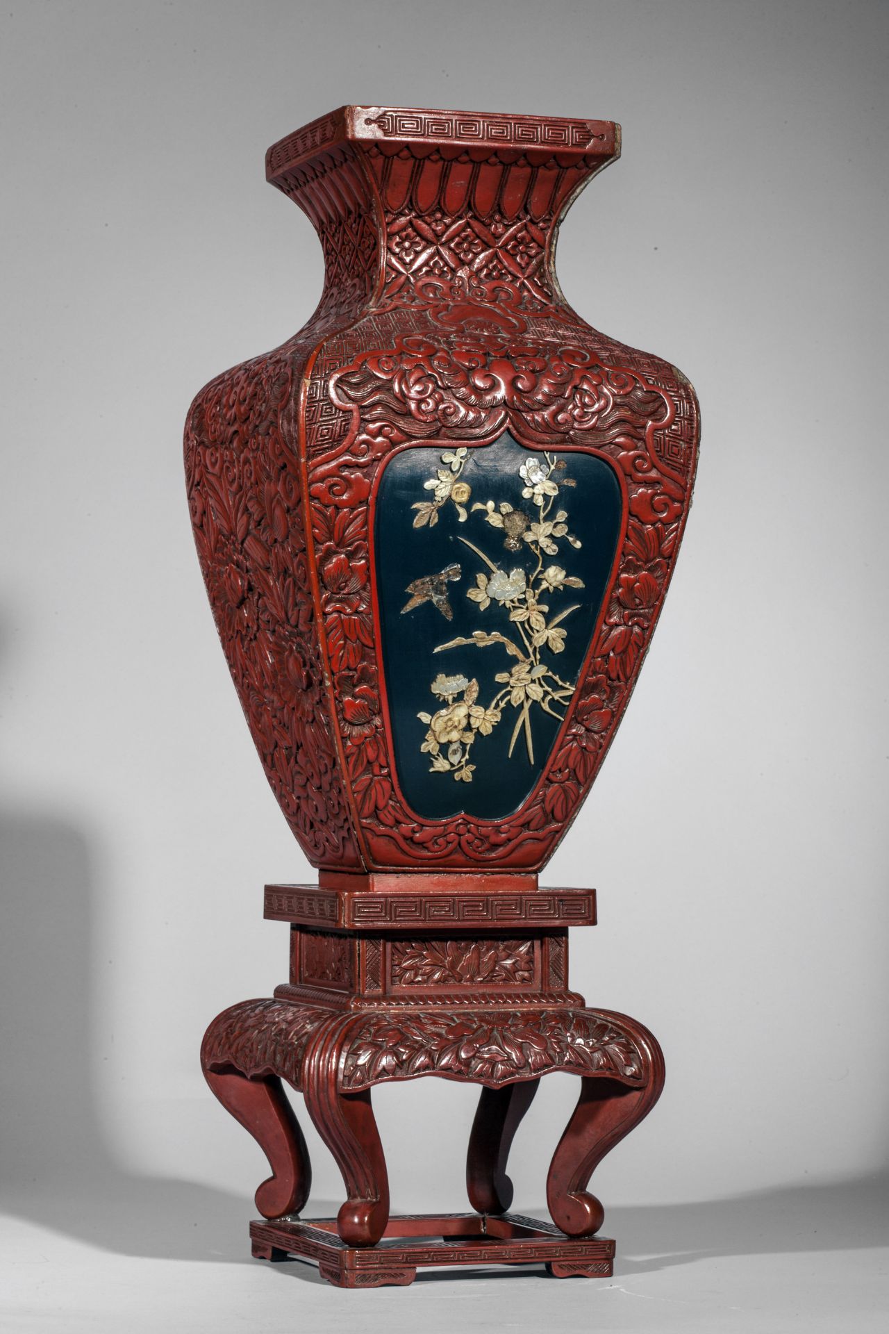 Vase quadrangulaire sur tablette quadripode en laque cinabre décoré sur deux réserves polylobées