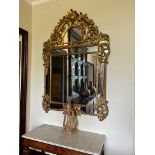 Grand miroir en bois doré à parcloses et fronton Décor d'aigles, de rinceaux feuillagés et fleuris